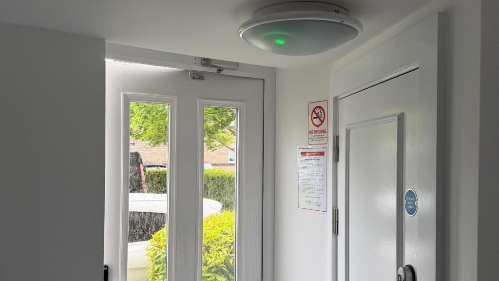 Emergency bulkhead light fitted in a communal hallway