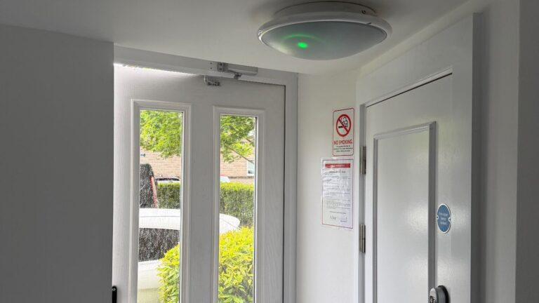 Emergency bulkhead light fitted in a communal hallway