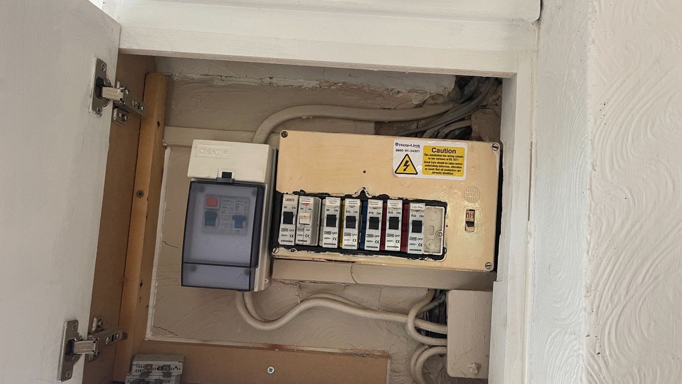 Old fuse board with rewireable fuses, the kind of installation a buyer may ask questions about