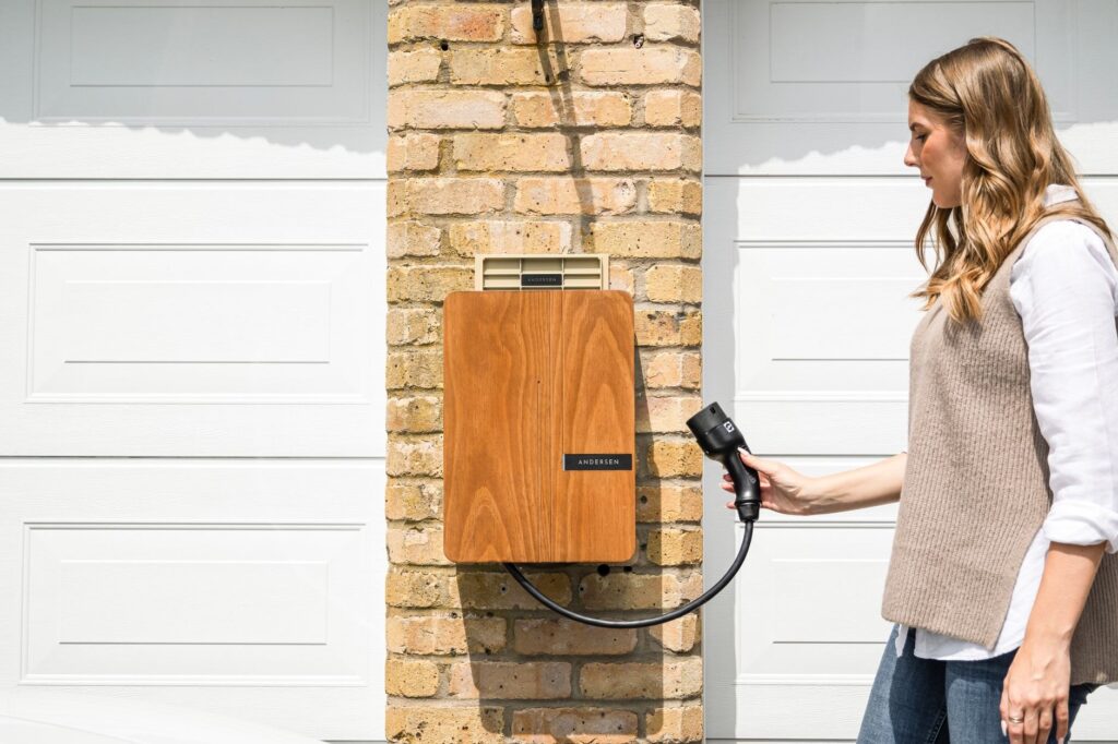 Home EV charger installation on the exterior wall of a UK house with the charging cable connected
